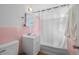 Bathroom with pink tile and a white vanity at 7711 King St, Westminster, CO 80030