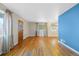 Bright living room with hardwood floors and a blue accent wall at 7711 King St, Westminster, CO 80030