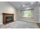 Spacious living room with a fireplace and a large window at 251 S Carter Ave, Louisville, CO 80027