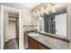 Bathroom with a vanity, mirror, and walk-in shower at 8653 E Dry Creek Rd # 1126, Englewood, CO 80112