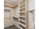 Large walk-in closet with shelves and hanging rods at 8653 E Dry Creek Rd # 1126, Englewood, CO 80112