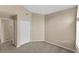 Simple bedroom with double door closet and neutral walls at 8653 E Dry Creek Rd # 1126, Englewood, CO 80112