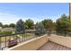 View from balcony overlooking a residential street with mature trees and parked cars at 8653 E Dry Creek Rd # 1126, Englewood, CO 80112