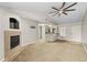 Bright living room featuring a fireplace and high ceilings at 8653 E Dry Creek Rd # 1126, Englewood, CO 80112