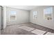 Spacious bedroom with carpet, two windows, and ample natural light at 10656 Akron St, Commerce City, CO 80640