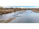 View of a calm river with grassy banks at 10656 Akron St, Commerce City, CO 80640