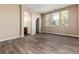 Bedroom with hardwood floors, large windows, and en-suite access at 22264 E Frost Pl, Aurora, CO 80016