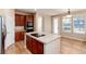 Kitchen island with cooktop and breakfast nook, hardwood floors and access to backyard at 22264 E Frost Pl, Aurora, CO 80016