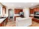 Spacious kitchen with island, stainless steel appliances, and wood flooring at 22264 E Frost Pl, Aurora, CO 80016