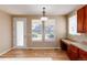 Bright kitchen nook with built-in workspace and backyard access at 22264 E Frost Pl, Aurora, CO 80016