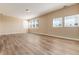 Large bonus room with hardwood floors and multiple windows at 22264 E Frost Pl, Aurora, CO 80016