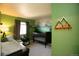 Bedroom with mountain mural, crib, and changing table at 1908 Homestead Dr, Fort Lupton, CO 80621