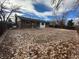 Large backyard with a brick house and leaf covered ground at 17337 E Flora Pl, Aurora, CO 80013