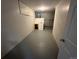 Unfinished basement with a utility sink and grey flooring at 17337 E Flora Pl, Aurora, CO 80013