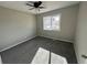 Bright bedroom with grey carpet and large window at 17337 E Flora Pl, Aurora, CO 80013