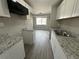 Modern kitchen with white cabinets, granite counters, and stainless steel sink at 17337 E Flora Pl, Aurora, CO 80013