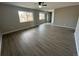 Bright living room featuring laminate floors and large windows at 17337 E Flora Pl, Aurora, CO 80013