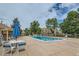 Community pool with lounge chairs and patio umbrella at 7370 E Florida Ave # 1020, Denver, CO 80231