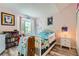 Bright bedroom with double bed, bookcase, and window at 7370 E Florida Ave # 1020, Denver, CO 80231