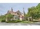 Tan two-story townhome with mature trees and landscaping at 7370 E Florida Ave # 1020, Denver, CO 80231