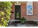 Front entrance of a brick home with a black door at 1166 Kearney St, Denver, CO 80220