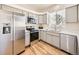Modern kitchen with stainless steel appliances and light cabinets at 7600 W Coal Mine Ave # B, Littleton, CO 80123