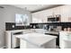 Updated kitchen featuring white cabinets and a kitchen island at 9790 Moss Rose Cir, Highlands Ranch, CO 80129