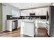 Modern kitchen with white cabinets, stainless steel appliances, and an island at 9790 Moss Rose Cir, Highlands Ranch, CO 80129