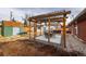 Backyard patio with pergola, hot tub, and two storage sheds at 2415 E Maplewood Ave, Centennial, CO 80121