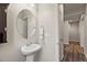 Small bathroom with pedestal sink and oval mirror at 863 Laramie Ln, Erie, CO 80516