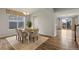 Dining room with hardwood floors, a table, and chairs, and access to the kitchen at 863 Laramie Ln, Erie, CO 80516