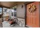 Inviting front porch with wicker chairs and a fall-themed wreath on the door at 863 Laramie Ln, Erie, CO 80516