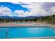 Community pool with mountain views and lounge chairs at 23485 Bluestem Dr, Golden, CO 80401