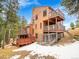 Two-story home with wooden exterior, deck, and mountain views at 23485 Bluestem Dr, Golden, CO 80401