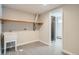 Basement laundry room with sink, shelving, and access to the bathroom at 1701 S Newport Way, Denver, CO 80224