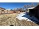 Backyard with grass, shed, and partial snow cover at 6601 E Exposition Ave, Denver, CO 80224