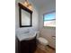 Updated bathroom with dark vanity and white tile at 6601 E Exposition Ave, Denver, CO 80224