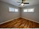 Bright bedroom with hardwood floors and ceiling fan at 6601 E Exposition Ave, Denver, CO 80224