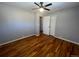 Bright bedroom with hardwood floors and ceiling fan at 6601 E Exposition Ave, Denver, CO 80224