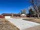 Brick Ranch home with a long driveway at 6601 E Exposition Ave, Denver, CO 80224