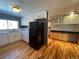 Updated kitchen with black appliances and wood floors at 6601 E Exposition Ave, Denver, CO 80224