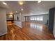 Open concept living room with hardwood floors and kitchen view at 6601 E Exposition Ave, Denver, CO 80224