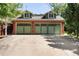 Spacious 3-car garage with light green doors and brick exterior at 790 Oneida St, Denver, CO 80220