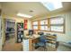 Well-lit office space with a desk, bookshelves, and comfortable seating at 461 Tyler Ave, Louisville, CO 80027