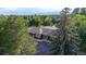 Aerial view of a single-story building with a large tree and mountain views at 461 Tyler Ave, Louisville, CO 80027