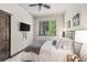 Serene bedroom with a queen-size bed and a wall-mounted TV, overlooking the woods at 378 River Park Dr, Breckenridge, CO 80424