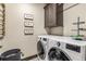 Convenient laundry room with a washer, dryer, and ample storage at 378 River Park Dr, Breckenridge, CO 80424