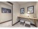 Home office with a wooden desk, two stools, and wall art at 378 River Park Dr, Breckenridge, CO 80424