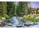Home nestled along a flowing river in a wooded area at 378 River Park Dr, Breckenridge, CO 80424