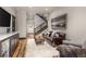 Cozy basement recreation room featuring a leather sofa, a large TV, and a stunning mountain landscape painting at 378 River Park Dr, Breckenridge, CO 80424